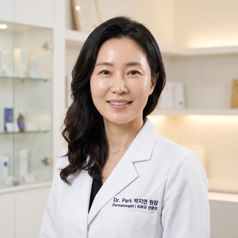 A professional woman in a white lab coat smiles in a modern clinical setting.